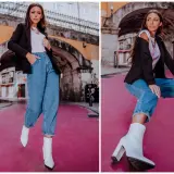 Kobieta w mom jeans i białych kozaczkach na słupku. Idealne buty do mom jeans, które podkreślą stylizację.