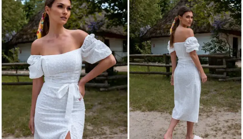 Kobieta w białej sukience hiszpance z bufiastymi rękawami i kolorową apaszką we włosach. Idealna fryzura do sukienki hiszpanki to luźne fale lub kucyk.