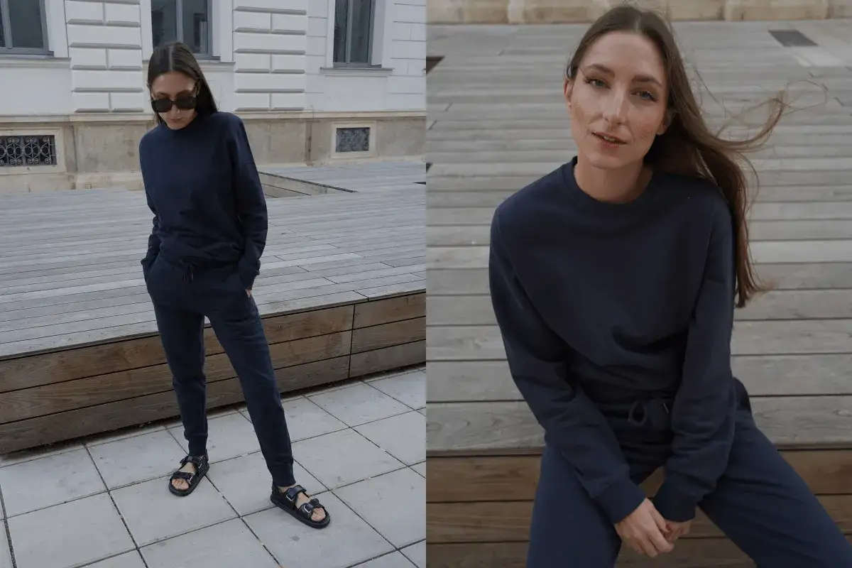 Kobieta w granatowym dresie. Bluza z okrągłym dekoltem, czyli crewneck, i spodnie dresowe tworzą wygodny zestaw.